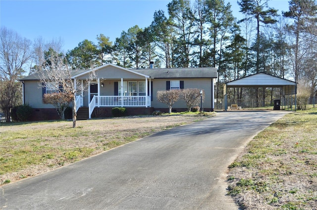 single story home with a carport, covered porch, and a front yard