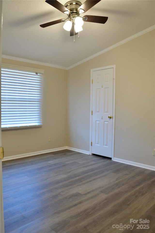 empty room with ornamental molding, dark hardwood / wood-style floors, and ceiling fan