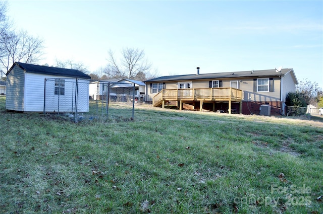 view of yard featuring cooling unit, a deck, and a storage shed