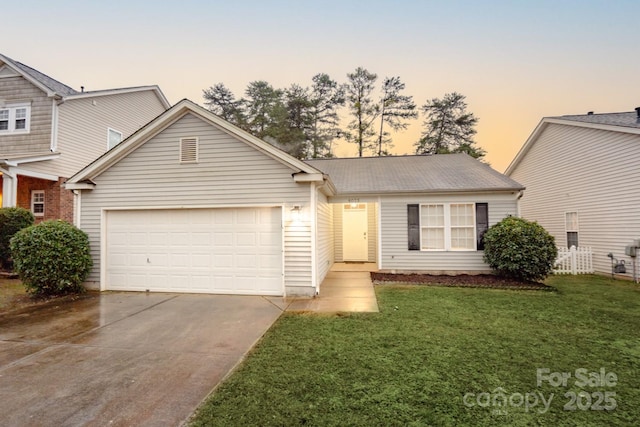 view of front of property featuring a yard and a garage