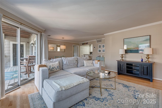 living room with crown molding and light hardwood / wood-style flooring