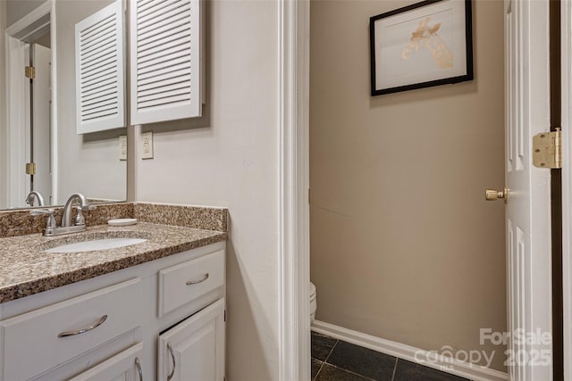 bathroom with vanity, tile patterned floors, and toilet