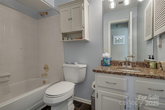 full bathroom featuring tiled shower / bath, vanity, and toilet