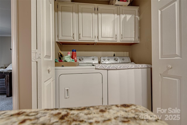 laundry area with cabinets and washing machine and clothes dryer