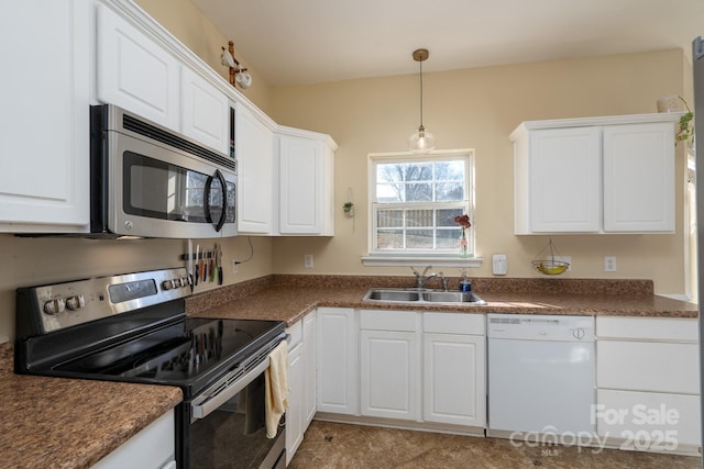 kitchen featuring hanging light fixtures, appliances with stainless steel finishes, sink, and white cabinets