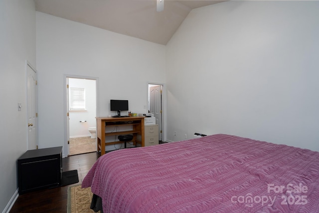 bedroom with ceiling fan, dark hardwood / wood-style flooring, high vaulted ceiling, and ensuite bath