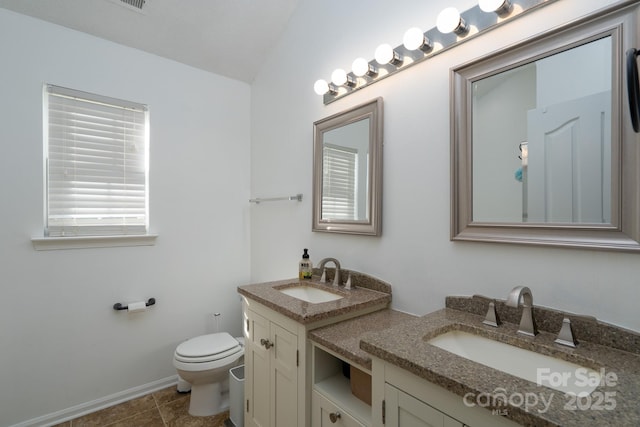 bathroom featuring vanity, toilet, and tile patterned flooring