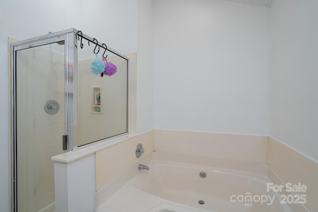 bathroom featuring shower with separate bathtub