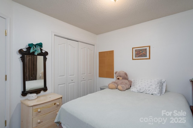 bedroom with a closet and a textured ceiling