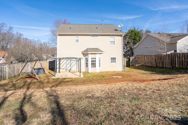 rear view of house with a patio and a yard