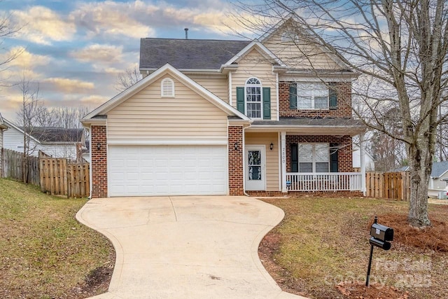 front of property with a garage, a porch, and a yard