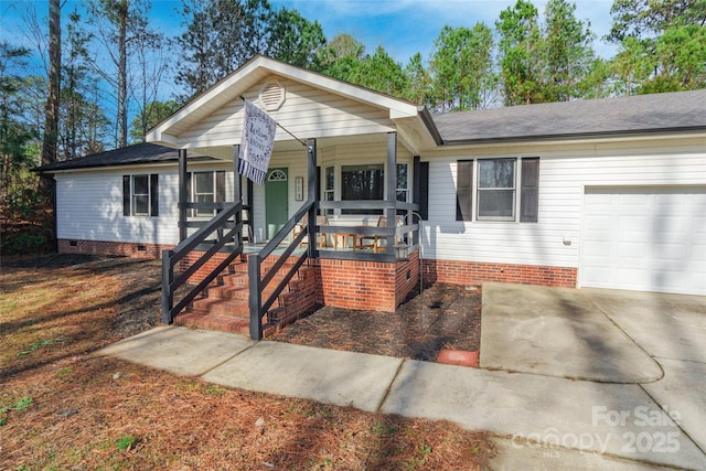 ranch-style house featuring a garage and covered porch