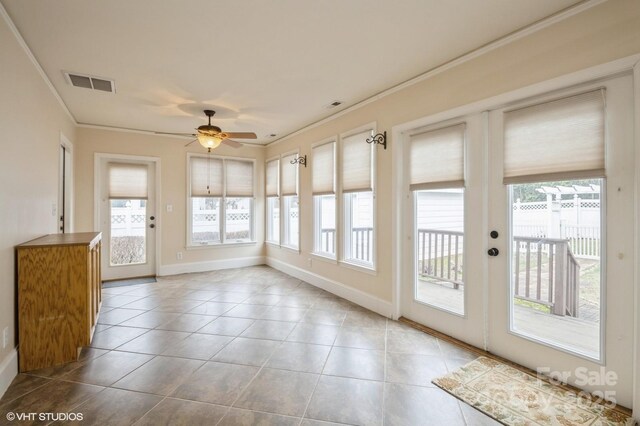 unfurnished sunroom featuring a wealth of natural light, tile patterned floors, and visible vents