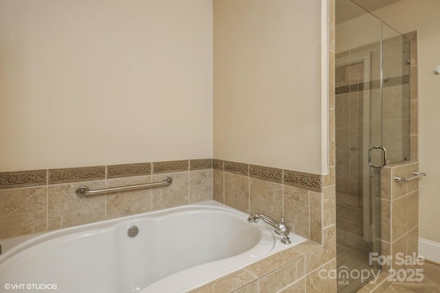 bathroom featuring a stall shower and a garden tub