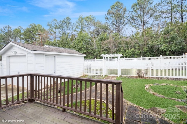 deck with an outbuilding, a fenced backyard, a detached garage, and a yard