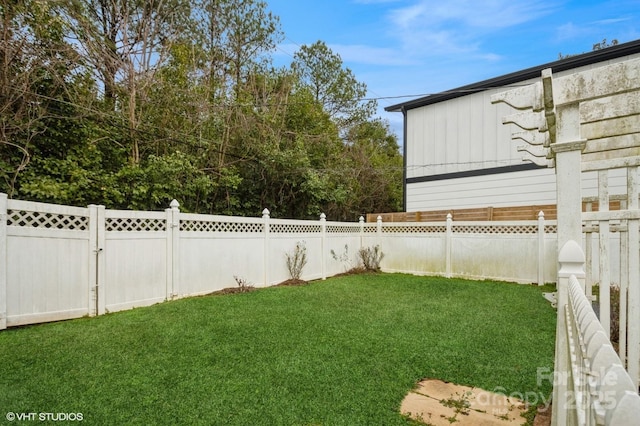 view of yard with a fenced backyard
