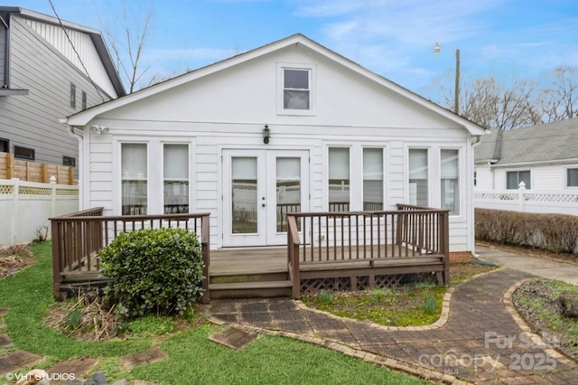 rear view of house featuring french doors, fence, and a deck