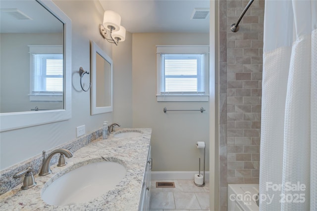 bathroom featuring tile patterned flooring, vanity, and shower / bath combo