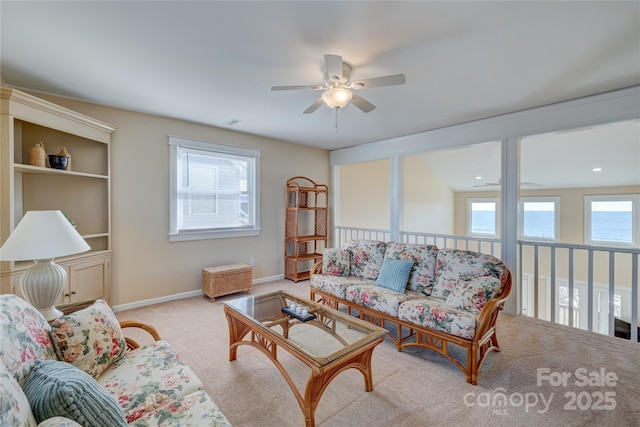 living room with light colored carpet and ceiling fan