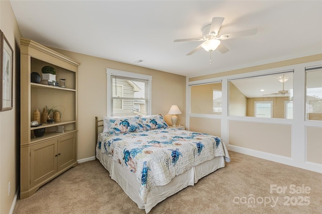 2221 E Beach Dr, Oak Island, NC 28465 - bedroom featuring light colored carpet, a ceiling fan, and baseboards