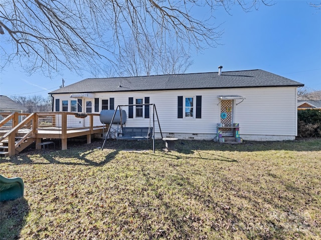 back of house featuring a deck and a lawn