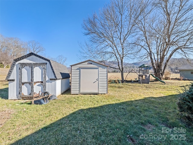 view of yard with a playground and a storage unit