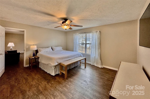 bedroom with ceiling fan, dark wood-style flooring, a textured ceiling, and baseboards