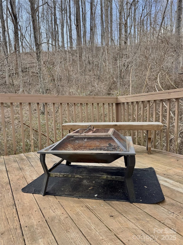 wooden terrace with a fire pit