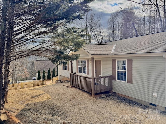 single story home with roof with shingles, crawl space, fence, and a wooden deck