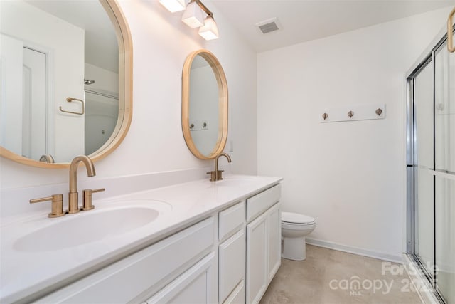 full bathroom featuring toilet, a shower with door, visible vents, and a sink