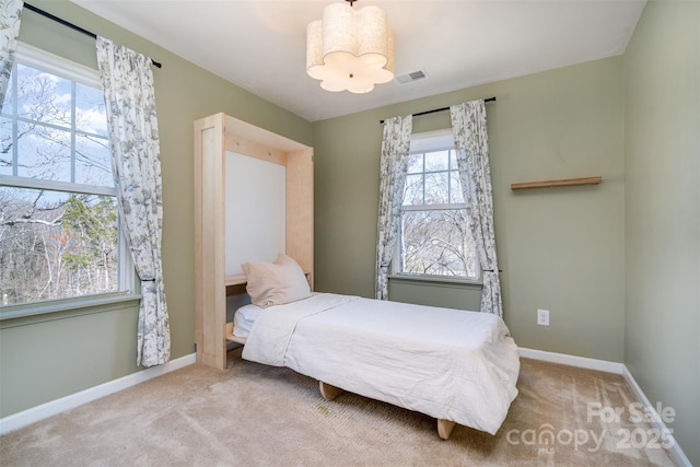 bedroom with carpet floors, baseboards, and visible vents