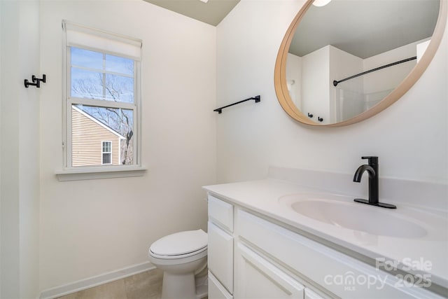 full bath with toilet, baseboards, and vanity