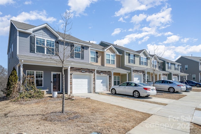 townhome / multi-family property with driveway, a garage, and a residential view