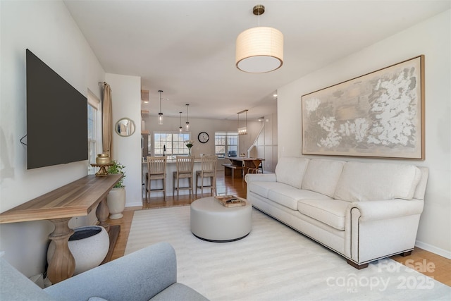 living room featuring baseboards and wood finished floors