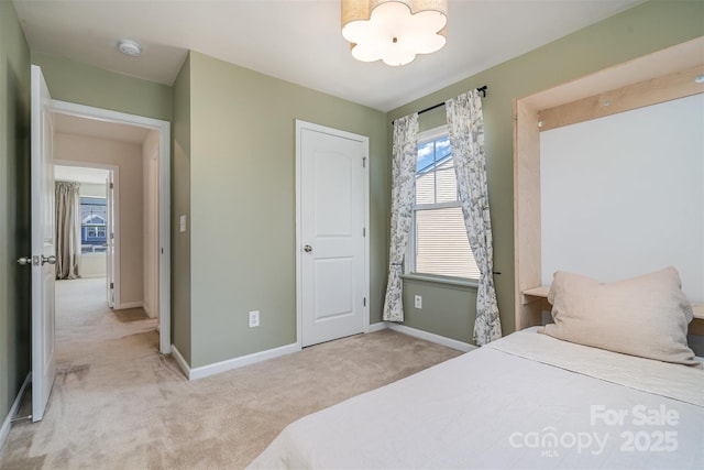 carpeted bedroom featuring baseboards