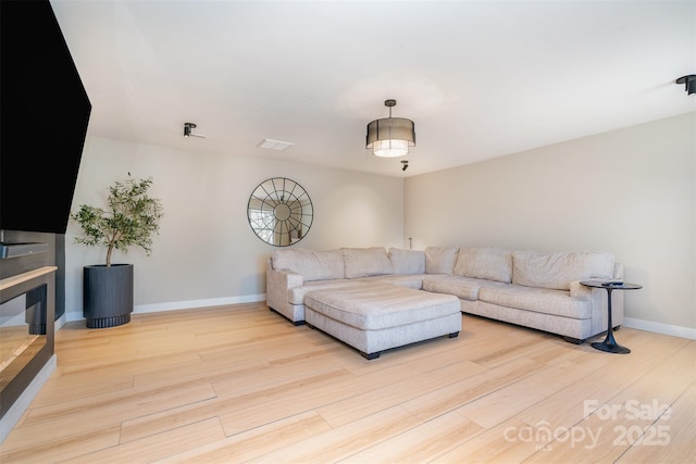 living area featuring wood finished floors and baseboards