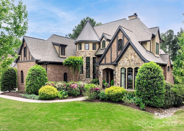 english style home with a front yard