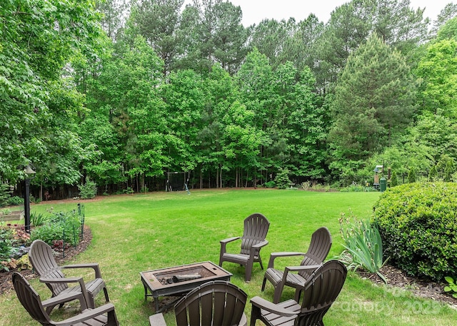 view of yard featuring an outdoor fire pit