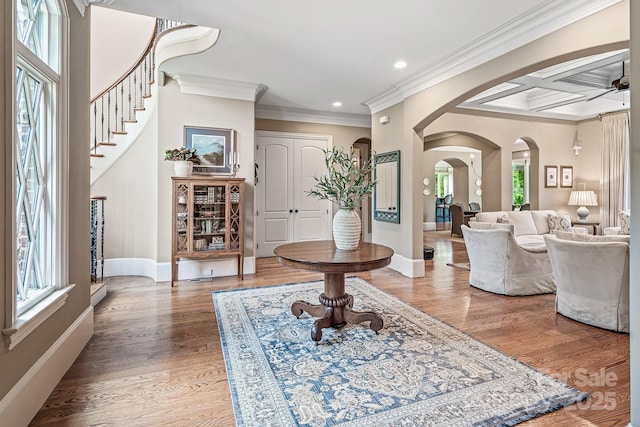 entrance foyer with beamed ceiling, crown molding, coffered ceiling, and hardwood / wood-style floors