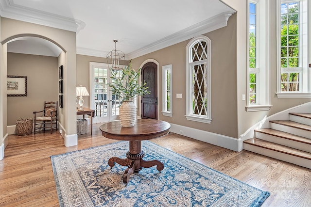 foyer featuring crown molding and light hardwood / wood-style floors