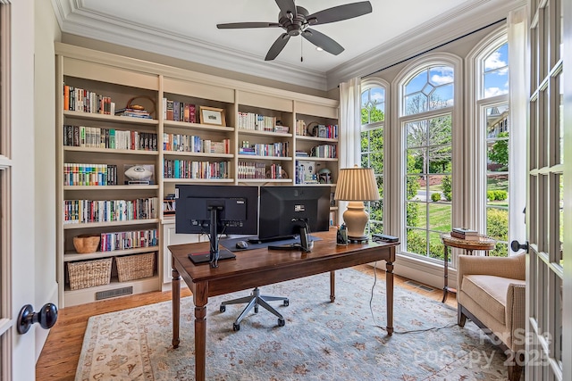 home office with crown molding, ceiling fan, and hardwood / wood-style floors