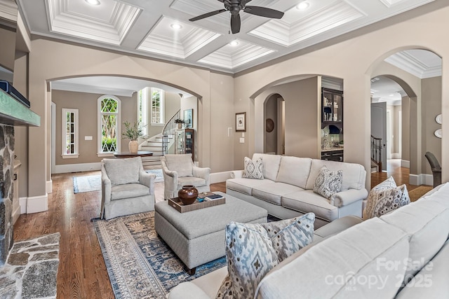 living room featuring beamed ceiling, crown molding, coffered ceiling, and dark hardwood / wood-style floors