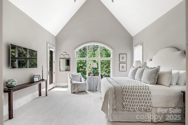 carpeted bedroom featuring high vaulted ceiling