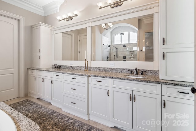 bathroom featuring vanity, tile patterned floors, ornamental molding, and a shower