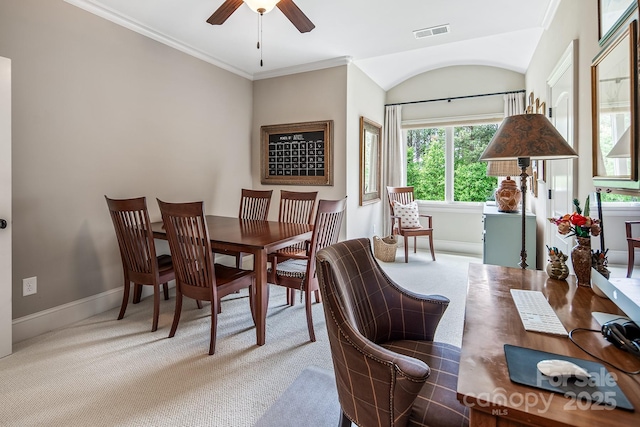 dining area with crown molding, carpet floors, and ceiling fan