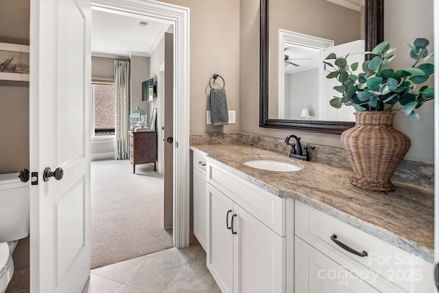 bathroom featuring vanity, tile patterned floors, and toilet