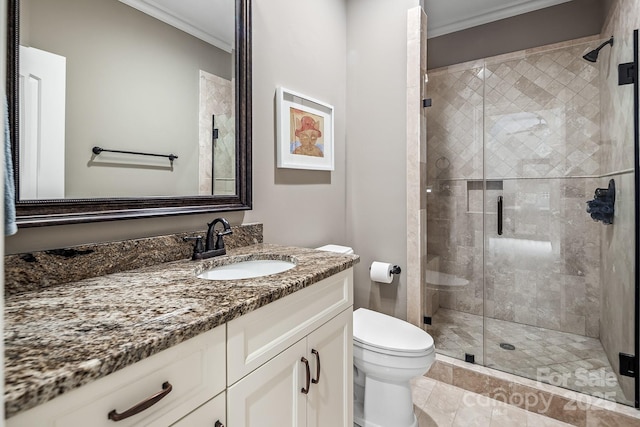 bathroom with vanity, an enclosed shower, crown molding, and toilet