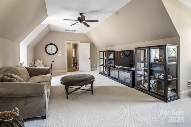 carpeted living room with ceiling fan and lofted ceiling