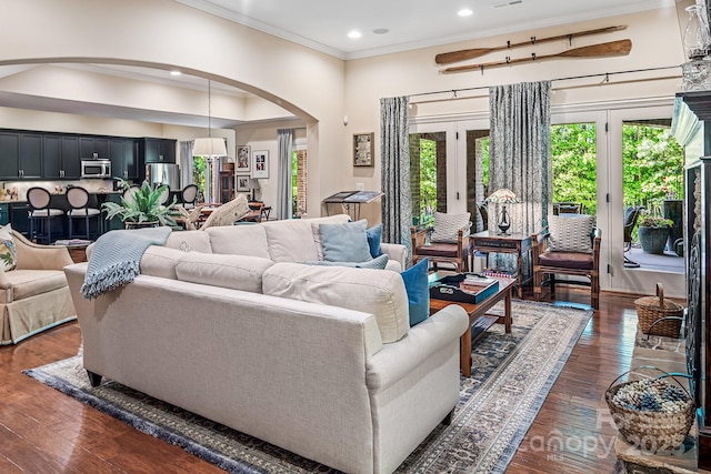 living room featuring ornamental molding and dark hardwood / wood-style floors