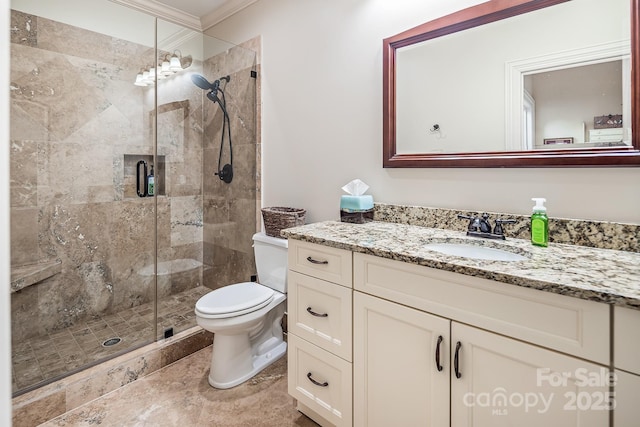 bathroom featuring crown molding, vanity, toilet, and a shower with door